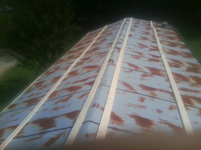 Rusted metal roof panels with new wood purlins before replacement — Storm Damage Roof Repair in Mount Gretna by Roofing Brothers