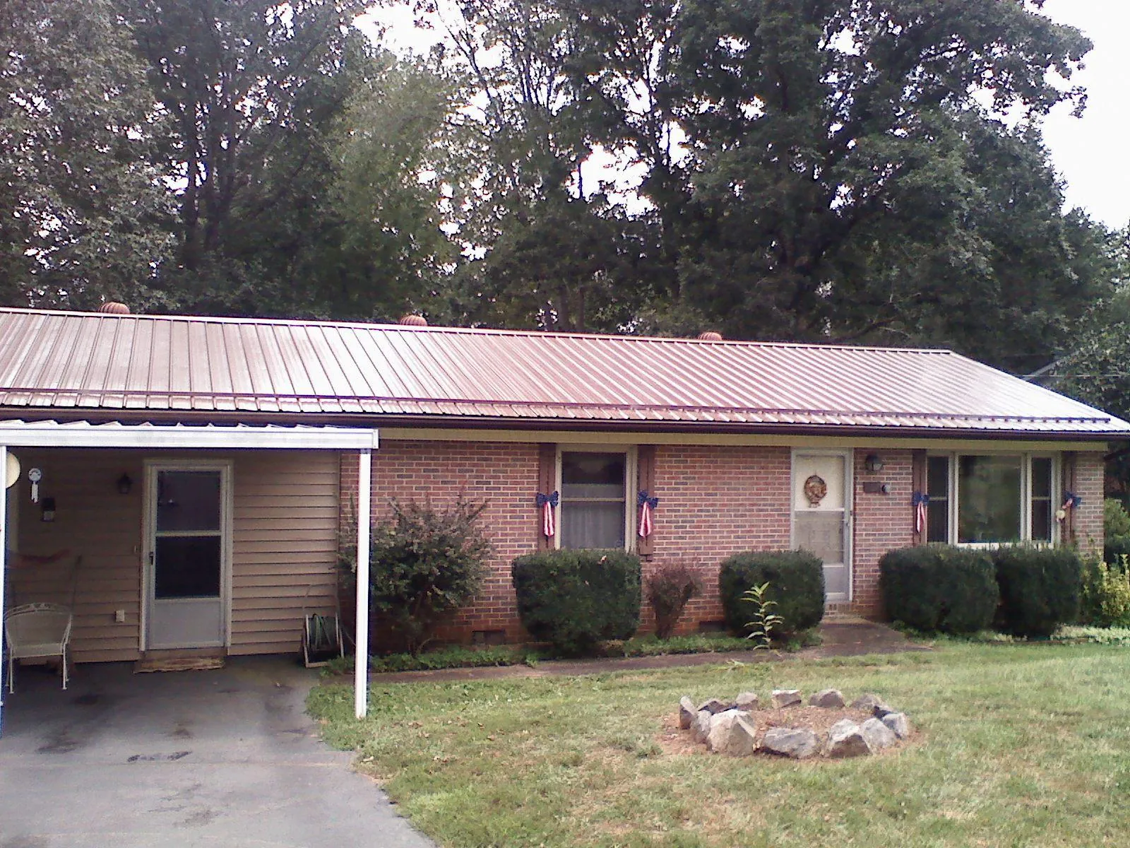 Bronze metal roof and carport on a brick ranch home — Roof Repair work by our crew in Mount Gretna