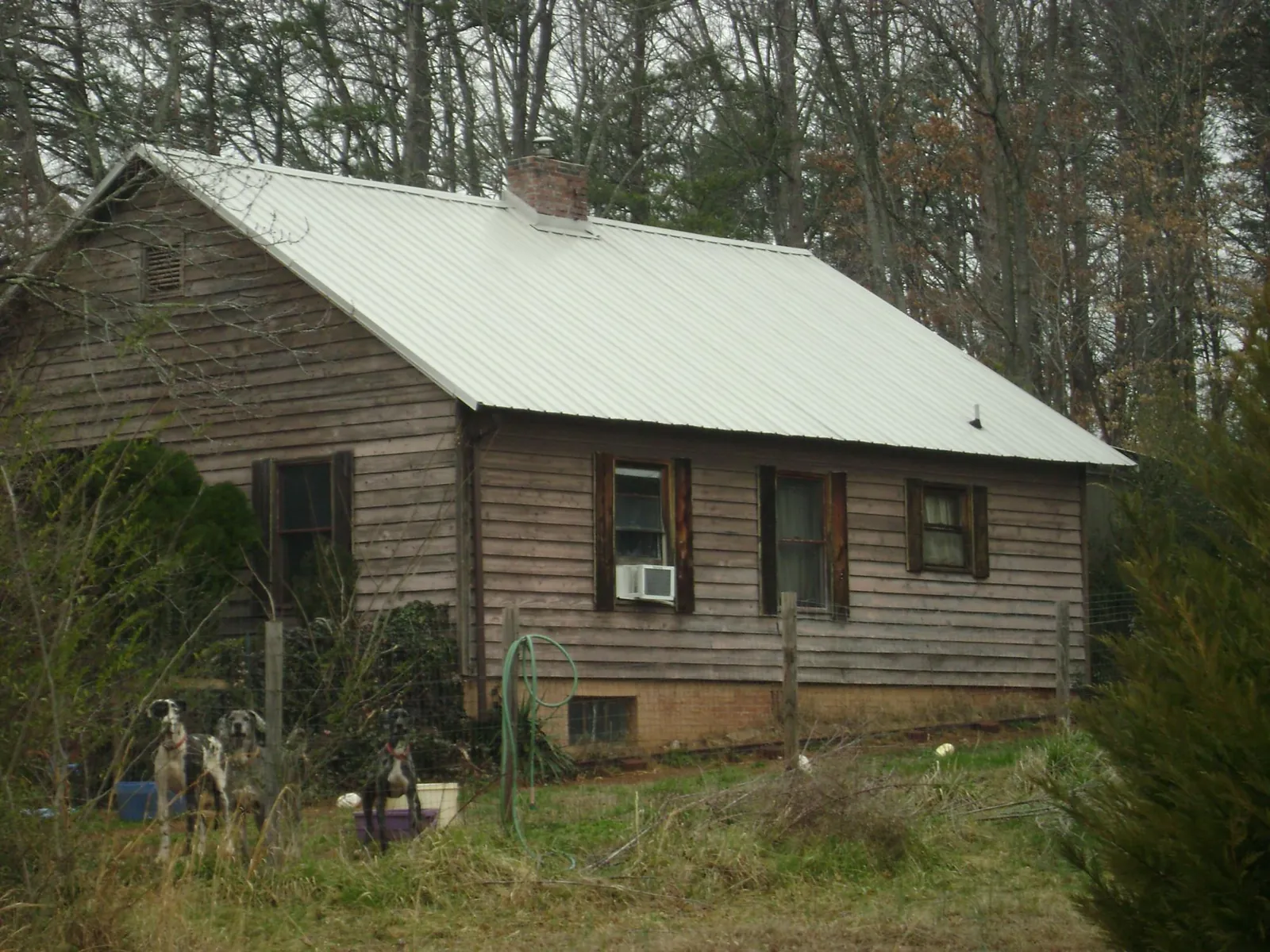 White metal roof on an old wood sided farmhouse, from a Metal Roof Installation job in Mount Gretna